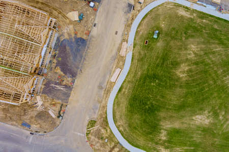 Aerial view of home framing of a new house under construction with stacker wooden boards the...