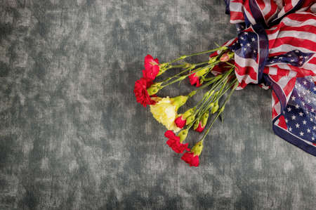 Remembrance pink carnation flowers for memorial celebration day with American Flagの写真素材