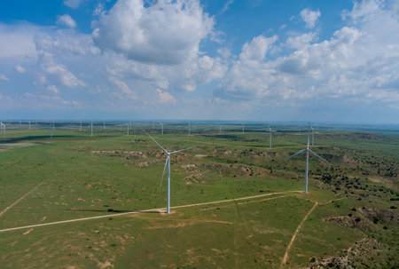 Wind turbines windmill energy farm in West Texas plains under a blue sky