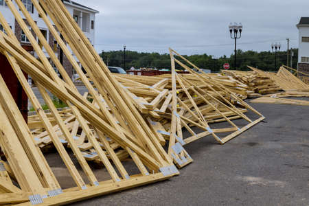 Wood stacked on house building materials from at a construction site.
