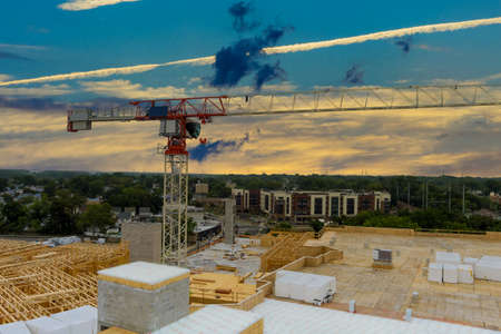Aerial view of construction tower cranes over under construction house a height
