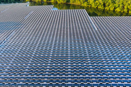 Aerial top view of renewable energy eco technology electric power industry. solar panels cells on floating in pond with water the power plantの写真素材