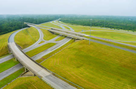 Misty morning over a desolate country road with bridge across US 65 Highway near Satsuma, Alabama in...