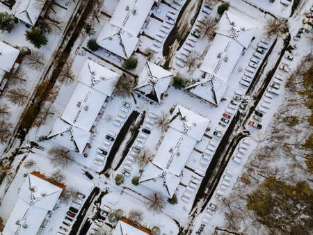 Panoramic top view on snow covered residential district apartment complex winter dayの写真素材