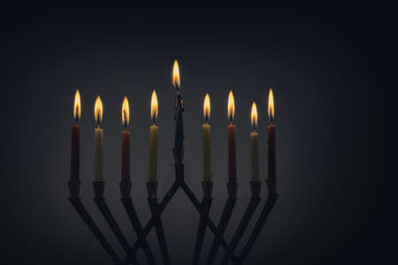 Candles lit for night of hanukkah menorah with burning candles for holidayの写真素材