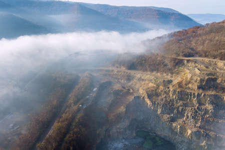 Mountain range with the morning fog natural stone quarry rocks in the slices