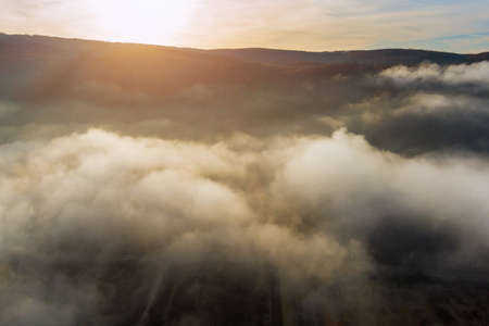 Autumn natural landscape the fantastic scenery with morning fog in forested mountainの写真素材