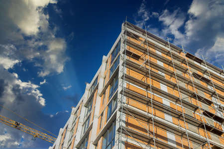 Many residential multi storey buildings under construction cranes is working on the construction