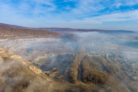 Majestic landscape of misty mountains with stone of quarry extracting work, mine industryの写真素材