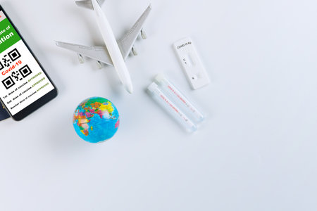 Smartphone with a digital of Covid-19 health vaccination passport a tube containing a swab sample for South African variant with new mutation coronavirus Omicronの写真素材