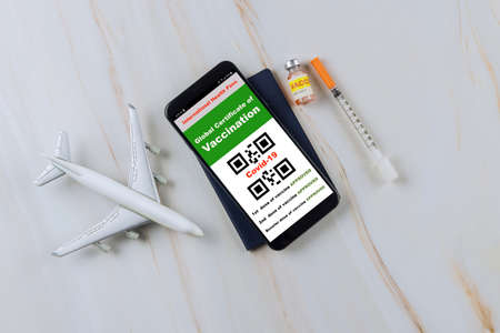 Displayed on a smartphone vaccination record that has been vaccinated with the Covid-19 vaccine travel themeの写真素材