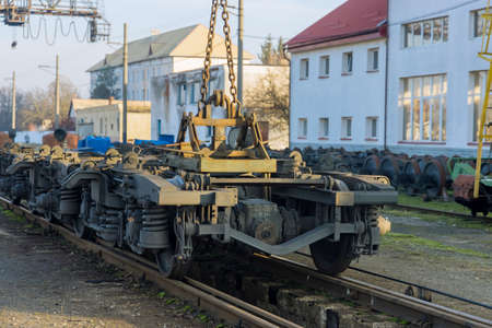 Railway stations in depot with industrial crane that raises the driving wheels for train