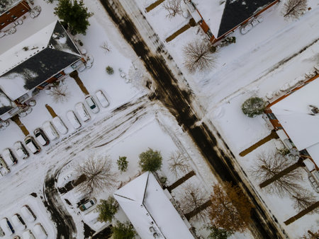 Snowy winter day on the in snow covered road near apartment complexの写真素材