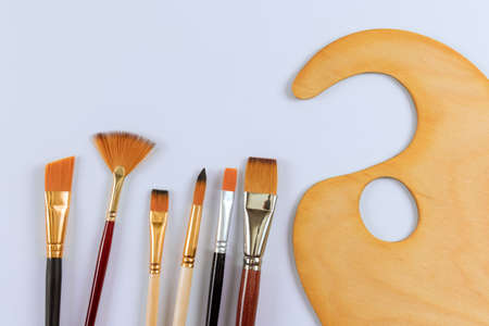 Drawing tools with paint artist brushes and palette for paint on white isolated background
