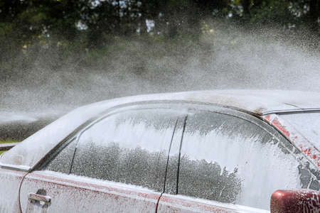 Close up of nozzle of high-pressure washer used on car washing in a self-serviceの写真素材