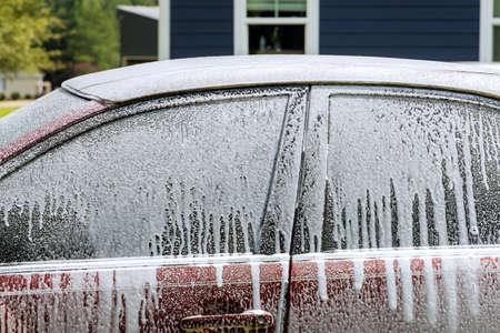 During cleaning in a car wash with foam wash on power water jet sprayingの写真素材