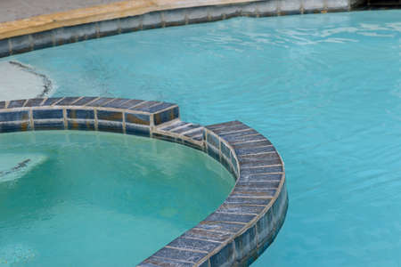 Empty outdoor swimming pool in resort with blue water
