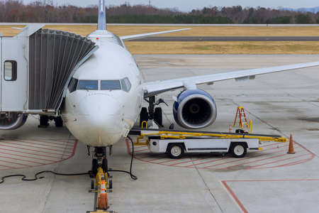 Loading of cargo containers to plane at preparing airplane before flight during sunny day