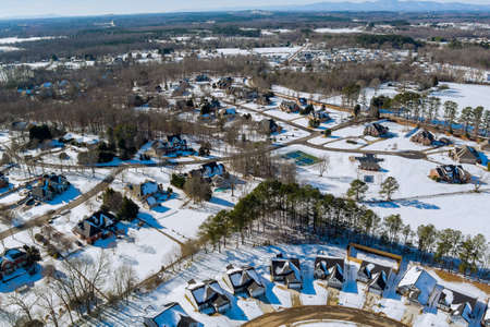 Winter white landscape small town in the houses complex area covered by snow of aerial top viewの写真素材