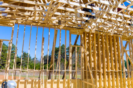 Construction team, new building construction with roof carpentry works on roof at height workers...