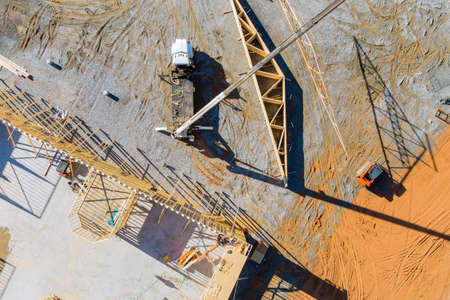 Construction a crane holds timber frame house of residential building with a without under...