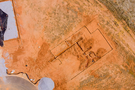 Aerial top view of new construction installation on water drainage system in new foundation