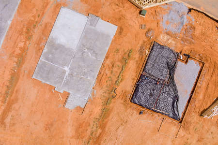Concrete foundation work of new housing under construction site with aerial top view