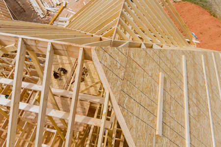 Standard timber roof frame of wooden rafters beams an exterior view house buildingの写真素材