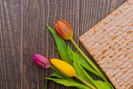 Passover Jewish holiday on flowers and matzah the wood tableの写真素材