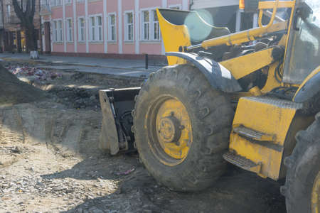 Heavy excavator excavating soil working during road works, moving gravel during construction of the...