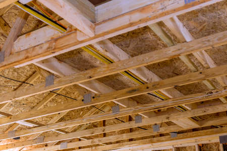 Installation of wooden with roof beams frame trusses condominium construction frameworkの写真素材