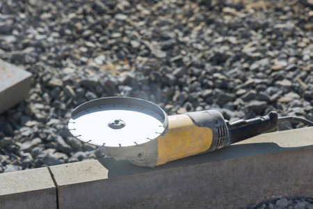 Concrete cutting with saw blade at construction at reconstruction area. Closeup