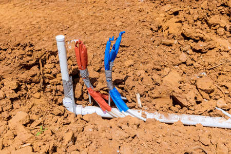 Plumbing work of assembling system laying from the ground of sanitary pvc sewage pipes in under constructionの写真素材