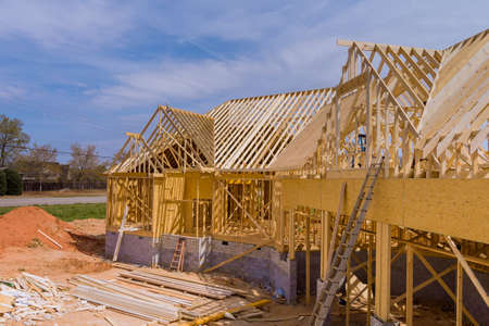Home construction the frame of house beginning on unfinished roofing construction