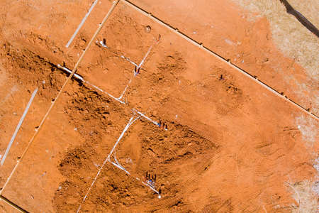 Laying water PVC plastic pipes and sewer sewage pipes system in ground during plumbing construction site under the foundation with aerial viewの写真素材