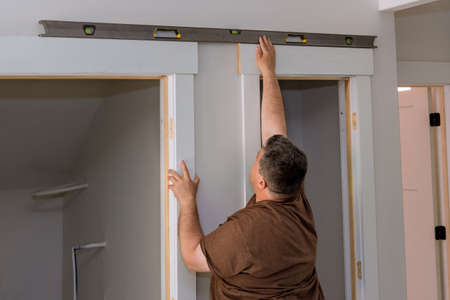 Carpenter at checks level correctness installation interior wood door