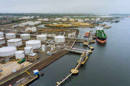 Cargo oil tanker is transferring oil to the crude oil storage an aerial view