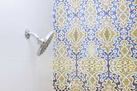 Shower turned on, overhead ceiling shower faucet head closeup in new master bathroomの写真素材