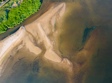 A top view from a height of a beach waves breaking on a sandy beach