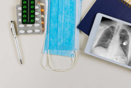With an x-ray and a monitor, the doctor checks the correct placement of a pacemaker in a medical officeの写真素材