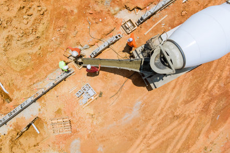 During construction of a new building, workers pour concrete columns in construction site