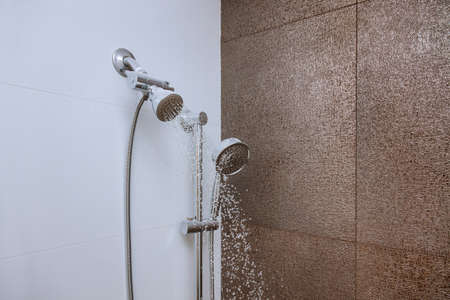 A of stainless steel shower head hanging from the wall in the bathroom
