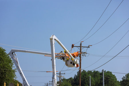 As a result of the storm, electrical workers are working in electric power pole maintenance industry...