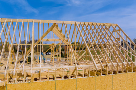For construction of new house, wooden truss roof beam is currently being erected