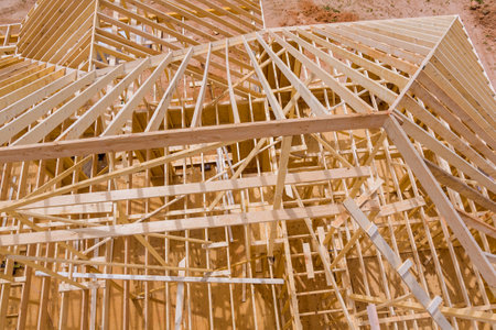 In process of constructing roof beams for new house based on wooden trusses