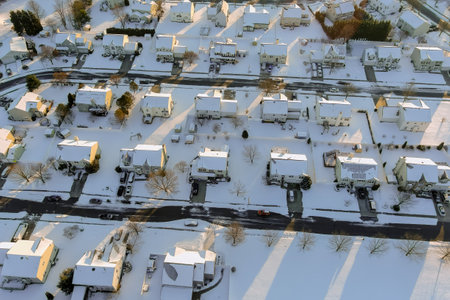 properties in small town in New Jersey with snow covered roofs after severe snowstorm hit area.の写真素材