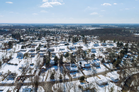 As result of an intense snowstorm in Pennsylvania, small American town residential complex that has snowy roof after severe storm hit the areaの写真素材