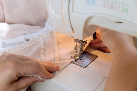 During workday, tailor seamstresses sew clothes on sewing machines in their workplace