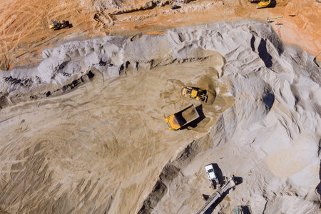 This is view stone crushing machine on mechanical conveyor belt as it grinding up rock stones so that gravel can be producedの写真素材