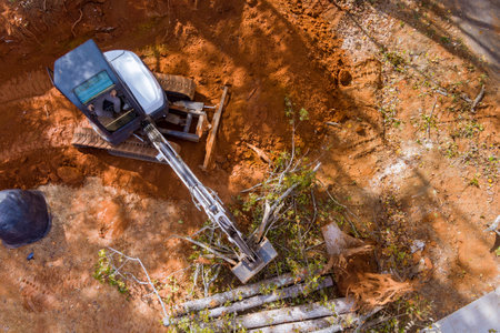 During landscaping work with tractors skid steers several sections of land had been cleared trees...